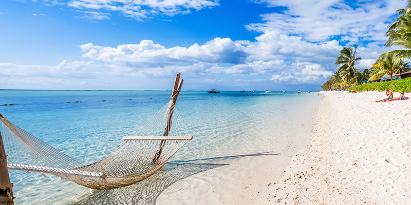 rope hammock over the shallow waters on the Caribbean islands